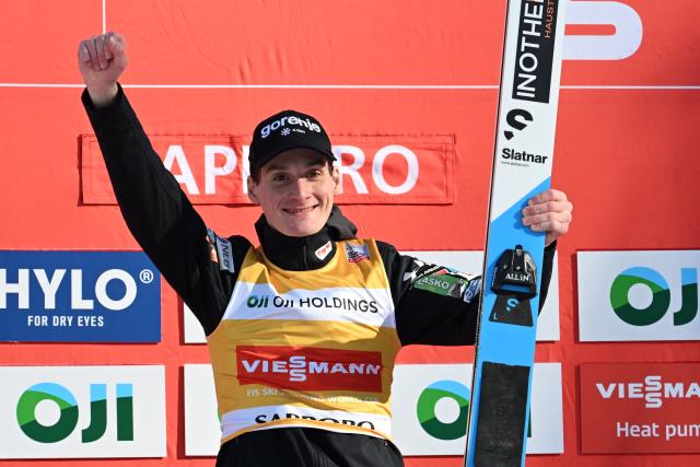 Winner Slovenia's Domen Prevc celebrates his victory on the podium during the individual Large Hill HS137 competition on the third day of men's FIS Ski Jumping World Cup competition in Sapporo on January 18, 2026. (Photo by Toshifumi KITAMURA / AFP)