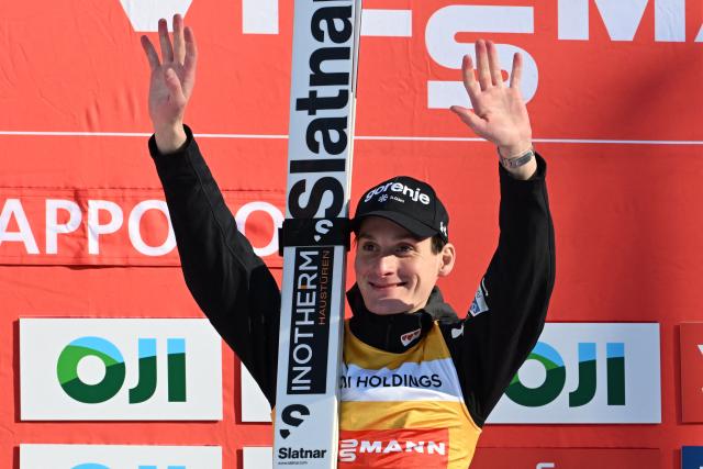 Winner Slovenia's Domen Prevc celebrates his victory on the podium during the individual Large Hill HS137 competition on the third day of men's FIS Ski Jumping World Cup competition in Sapporo on January 18, 2026. (Photo by Toshifumi KITAMURA / AFP)