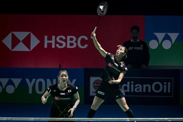 Japan’s Yuki Fukushima (R) and Mayu Matsumoto (L) play a return against China’s Liu Sheng Shu and Tan Ning during their women’s doubles final match at the India Open 2026 badminton tournament in New Delhi on January 18, 2026. (Photo by Sajjad  HUSSAIN / AFP)