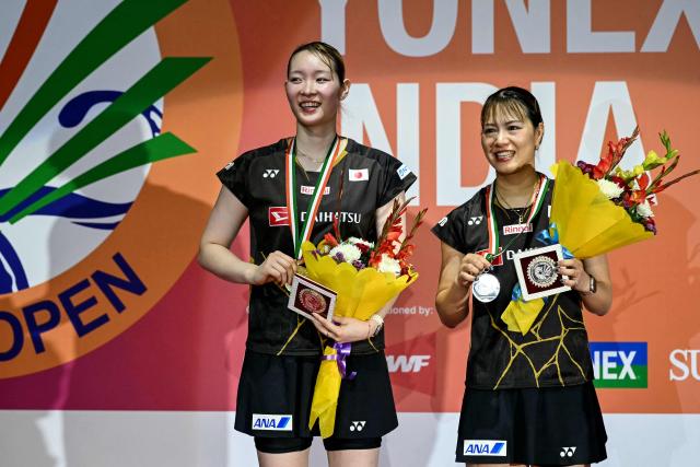Silver medallists Japan’s Yuki Fukushima (R) and Mayu Matsumoto (L) pose during the awards ceremony after their women’s doubles final match against China’s Liu Sheng Shu and Tan Ning at the India Open 2026 badminton tournament in New Delhi on January 18, 2026. (Photo by Sajjad HUSSAIN / AFP)