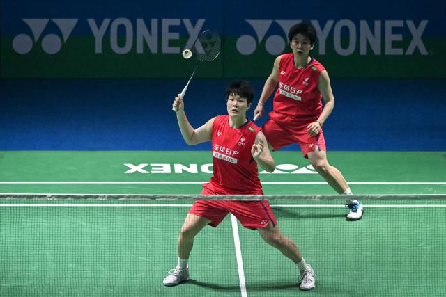China’s Liu Sheng Shu (L) and Tan Ning (R) play a return against Japan’s Yuki Fukushima and Mayu Matsumoto during their women’s doubles final match at the India Open 2026 badminton tournament in New Delhi on January 18, 2026. (Photo by Sajjad HUSSAIN / AFP)