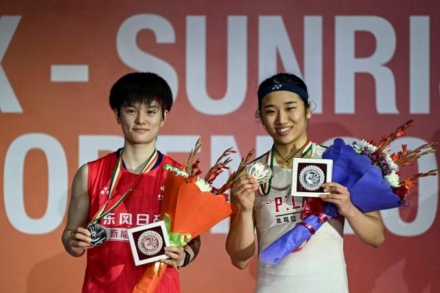 Gold medallist South Korea’s An Se-young (R) and silver medallist China's Wang Zhi Yi pose during the awards ceremony after the women’s singles final match at the India Open 2026 badminton tournament in New Delhi on January 18, 2026. (Photo by Sajjad HUSSAIN / AFP)
