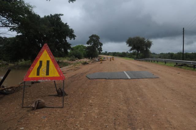 A general view of a damaged road on the way from Giyani to Mbaula on January 17, 2026 following heavy rains over much of the Limpopo Province, South Africa. Heavy rains have drenched the northeast of the country since late last year, claiming at least 30 lives. (Photo by LUCAS LEDWABA / AFP)