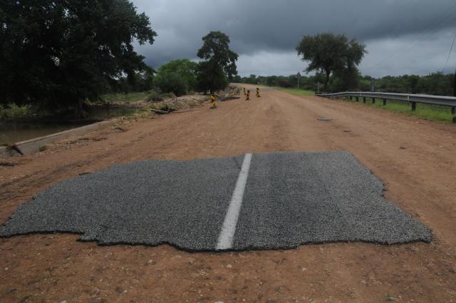 A general view of a damaged road on the way from Giyani to Mbaula on January 17, 2026 following heavy rains over much of the Limpopo Province, South Africa. Heavy rains have drenched the northeast of the country since late last year, claiming at least 30 lives. (Photo by LUCAS LEDWABA / AFP)