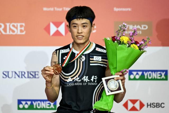 Taiwan’s Lin Chun-yi poses during the awards ceremony after the men's singles final match at the India Open 2026 badminton tournament in New Delhi on January 18, 2026. (Photo by Sajjad HUSSAIN / AFP)