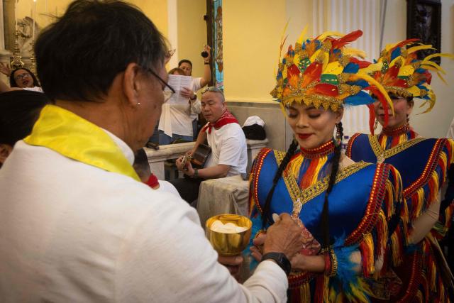 Members of the congregation receive the Euricharist at the mass in St. Lawrence Churh during the Sinulog Festival, which honours the Santo Niño (child Jesus), in Macau on January 18, 2026. (Photo by Eduardo Leal / AFP)