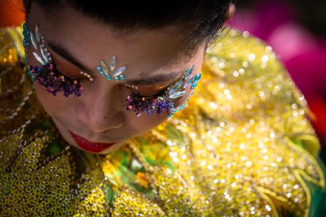 A member of Debutantes de Macau waits for the beginning of their performance during the Sinulog Festival, which honours the Santo Niño (child Jesus), in Macau on January 18, 2026. (Photo by Eduardo Leal / AFP)