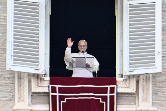 Pope Leo XIV addresses the crowd from the window of the apostolic palace overlooking St. Peter's square during the Angelus prayer in The Vatican on January 18, 2026. (Photo by Tiziana FABI / AFP)