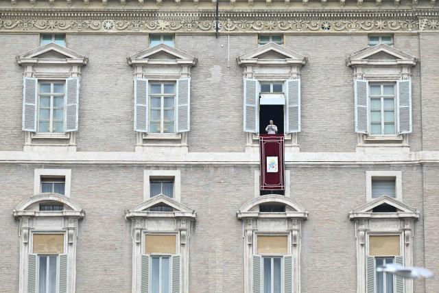 Pope Leo XIV addresses the crowd from the window of the apostolic palace overlooking St. Peter's square during the Angelus prayer in The Vatican on January 18, 2026. (Photo by Tiziana FABI / AFP)
