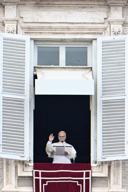 Pope Leo XIV addresses the crowd from the window of the apostolic palace overlooking St. Peter's square during the Angelus prayer in The Vatican on January 18, 2026. (Photo by Tiziana FABI / AFP)