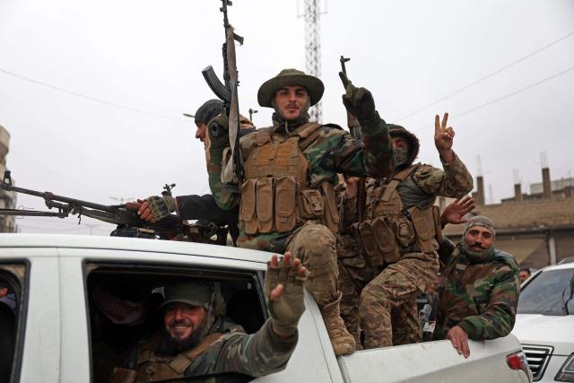 Syrian government troops patrol through the streets of Tabqa, in Raqa province, on the southwestern banks of the Euphrates on January 18, 2026. Kurdish-led forces withdrew on January 18 from Syria's largest oil field, a conflict monitor said, as government troops extended their grip over swathes of territory in the country's north and east. Government troops drove Kurdish forces from two Aleppo neighbourhoods following clashes last week, and on January 17 announced they had captured an area east of the city, as well as Tabqa. (Photo by OMAR HAJ KADOUR / AFP)