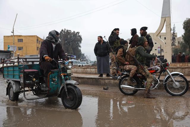 Syrian government troops on a motorbike patrol through the streets of Tabqa, in Raqa province, on the southwestern banks of the Euphrates on January 18, 2026. Kurdish-led forces withdrew on January 18 from Syria's largest oil field, a conflict monitor said, as government troops extended their grip over swathes of territory in the country's north and east. Government troops drove Kurdish forces from two Aleppo neighbourhoods following clashes last week, and on January 17 announced they had captured an area east of the city, as well as Tabqa. (Photo by OMAR HAJ KADOUR / AFP)