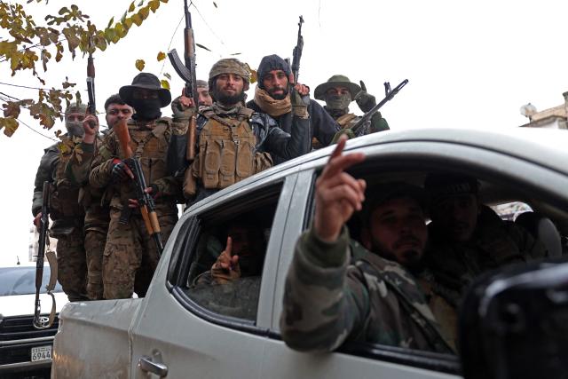 Syrian government troops patrol through the streets of Tabqa, in Raqa province, on the southwestern banks of the Euphrates on January 18, 2026. Kurdish-led forces withdrew on January 18 from Syria's largest oil field, a conflict monitor said, as government troops extended their grip over swathes of territory in the country's north and east. Government troops drove Kurdish forces from two Aleppo neighbourhoods following clashes last week, and on January 17 announced they had captured an area east of the city, as well as Tabqa. (Photo by OMAR HAJ KADOUR / AFP)