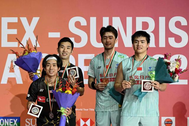 Gold medallists China's Liang Wei Keng (R) and Wang Chang (2R) pose alongside silver medallists Japan’s Hiroki Midorikawa (L) and Kyohei Yamashita during the awards ceremony for the men's doubles final match at the India Open 2026 badminton tournament in New Delhi on January 18, 2026. (Photo by Sajjad HUSSAIN / AFP)