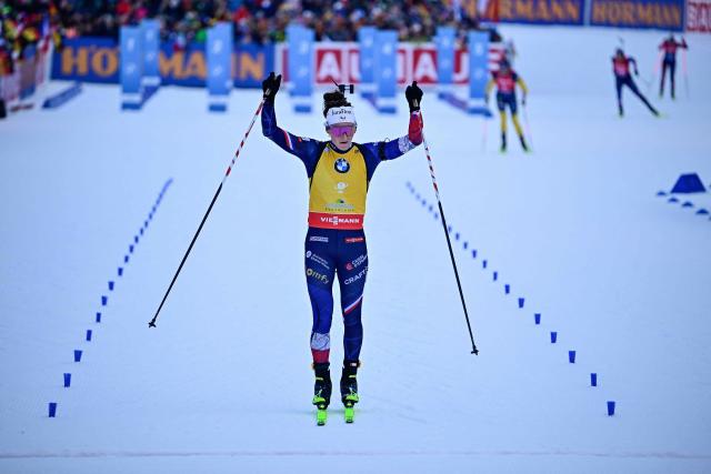 France's Lou Jeanmonnot-Laurent reacts as she crosses the finish line to win the women's Pursuit competition of the IBU Biathlon World Cup in Ruhpolding, southern Germany on January 18, 2026. (Photo by Tobias SCHWARZ / AFP)