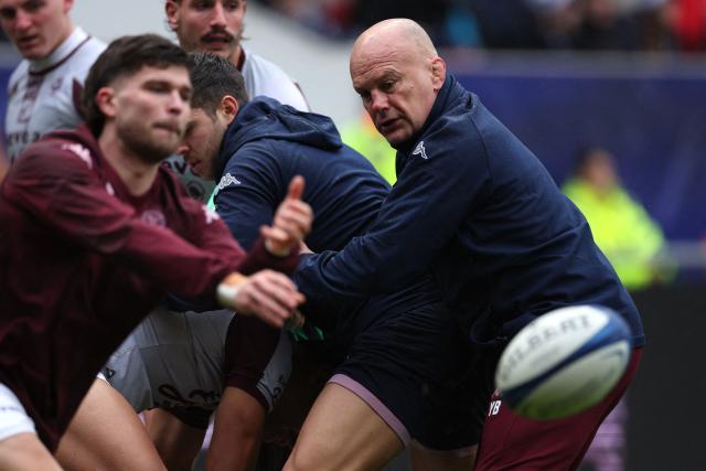 Bordeaux-Begles' French head coach Yannick Bru (R) watches his players warm up ahead of the European Champions Cup Pool 4 rugby union match between Bristol Bears and Union Bordeaux Begles at Ashton Gate stadium in Bristol, south-west England on January 18, 2026. (Photo by Adrian Dennis / AFP)