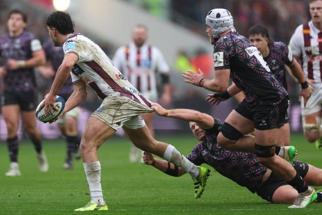 Bordeaux-Begles' French centre Nicolas Depoortere is grabbed by Bristol's English centre James Williams during the European Champions Cup Pool 4 rugby union match between Bristol Bears and Union Bordeaux Begles at Ashton Gate stadium in Bristol, south-west England on January 18, 2026. (Photo by Adrian Dennis / AFP)