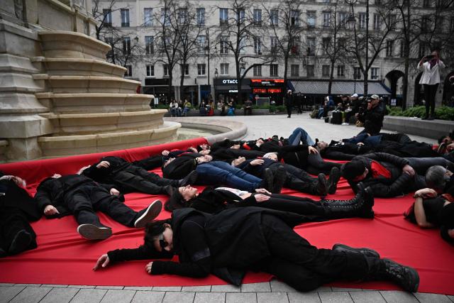 Iranian director Sepideh Farsi (foreground) and fellow demonstrators take part in a die-in protest in support of the Iranian People in front of the Fontaine des Innocents on Place Joachim du Bellay in Paris on January 18, 2026. (Photo by JULIEN DE ROSA / AFP)