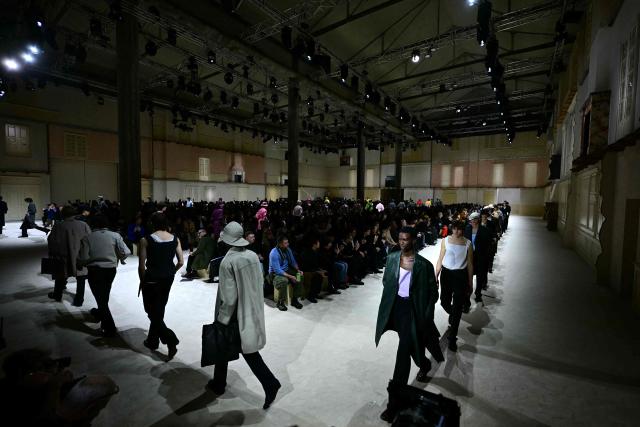 Models walk the runway during the Prada collection show as part of Men's Fall/Winter 2026-2027 Milan's fashion week, on January 18, 2026. (Photo by Stefano RELLANDINI / AFP)