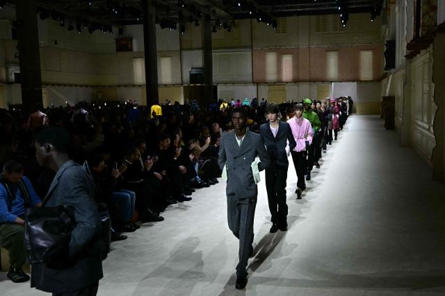 Models walk the runway during the Prada collection show as part of Men's Fall/Winter 2026-2027 Milan's fashion week, on January 18, 2026. (Photo by Stefano RELLANDINI / AFP)