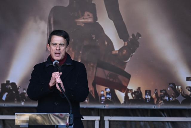 Former French Prime Minister Manuel Valls  delivers remarks during the March for Iran rally in support of the Iranian people, called by pro-royalists and supporters of the son of the last shah of Iran Mohammad Reza Pahlavi at the Place Victor Hugo, in Paris on January 18, 2026. (Photo by JULIEN DE ROSA / AFP)