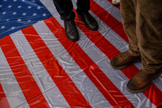 Protesters step on a US national flag during a pro-Iranian regime demonstration in front of the Iranian consulate in Istanbul, on January 18, 2026. Iranian authorities have said they are considering "gradually" restoring internet access after imposing an unprecedented communications shutdown 10 days ago, which rights groups say masked a violent protest crackdown that killed thousands. Demonstrations sparked in late December by anger over economic hardship exploded into protests widely seen as the biggest challenge to the Iranian leadership in years. (Photo by Ozan KOSE / AFP)