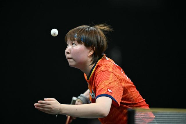 Macoa's Zhu Yuling serves against Japan's Hitomi Sato during the final's of the Woman's World Table Tennis (WTT) Star Contender tournament at the Lusail Sports Areana, in Doha on January 18, 2026. (Photo by Mahmud HAMS / AFP)