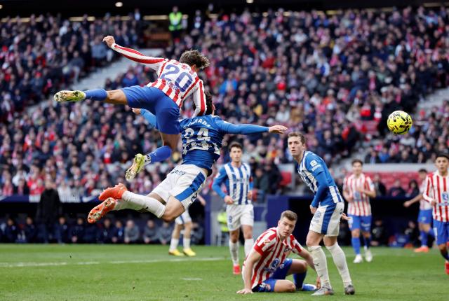 TOPSHOT - Atletico Madrid's Argentine forward #20 Giuliano Simeone and Alaves' Spanish defender #24 Victor Parada jump for the ball during the Spanish league football match between Club Atletico de Madrid and Deportivo Alaves at Metropolitano Stadium in Madrid on January 18, 2026. (Photo by Oscar DEL POZO / AFP)