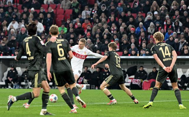 Stuttgart's German midfielder #10 Chris Fuehrich (C) shoots the ball to score the 1-0 opening goal during the German first division Bundesliga football match between VfB Stuttgart and Union Berlin in Stuttgart, southern Germany, on January 18, 2026. (Photo by THOMAS KIENZLE / AFP) / DFL REGULATIONS PROHIBIT ANY USE OF PHOTOGRAPHS AS IMAGE SEQUENCES AND/OR QUASI-VIDEO