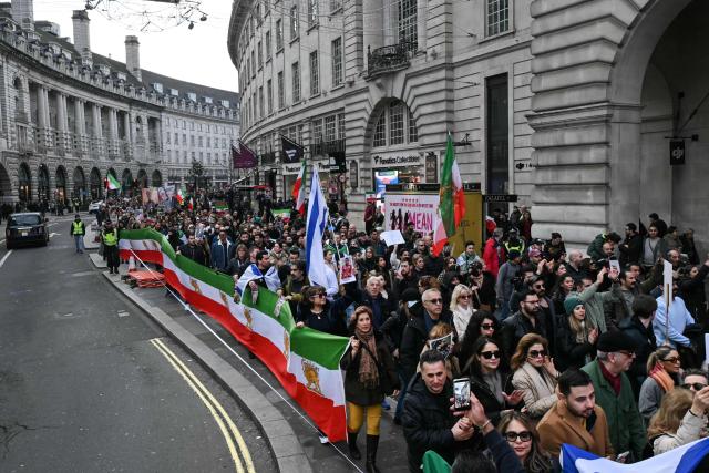 Protesters take part in a march to Downing Street against Iran's crackdown on protesters, in London on January 18, 2026. (Photo by JUSTIN TALLIS / AFP)
