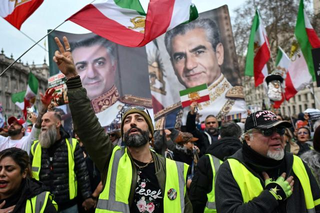 Protesters sing the Iranian national anthem as they take part in a march to Downing Street against Iran's crackdown on protesters, in London on January 18, 2026. (Photo by JUSTIN TALLIS / AFP)
