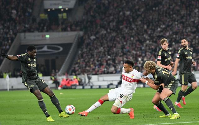 (L-R Union Berlin's French defender #34 Stanley Nsoki, Stuttgart's German forward #18 Jamie Leweling and Union Berlin's Austrian defender #14 Leopold Querfeld vie for the ball during the German first division Bundesliga football match between VfB Stuttgart and Union Berlin in Stuttgart, southern Germany, on January 18, 2026. (Photo by THOMAS KIENZLE / AFP) / DFL REGULATIONS PROHIBIT ANY USE OF PHOTOGRAPHS AS IMAGE SEQUENCES AND/OR QUASI-VIDEO