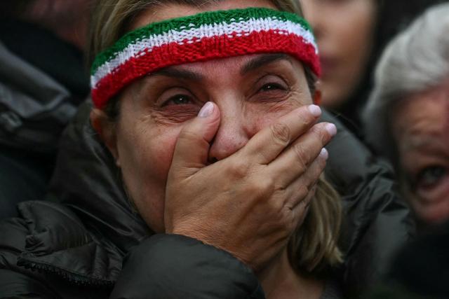 A woman reacts after singing the Iranian national anthem as people take part in a march to Downing Street against Iran's crackdown on protesters, in London on January 18, 2026. (Photo by JUSTIN TALLIS / AFP)