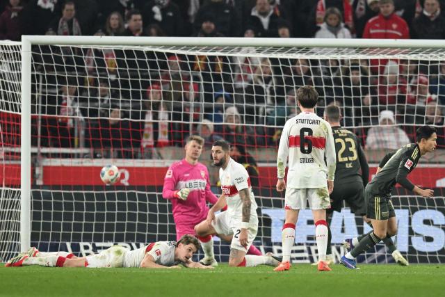 Union Berlin's South Korean midfielder #11 Jeong Woo-yeong (R) reacts after scoring the 1-1 goal past Stuttgart's German goalkeeper #33 Alexander Nuebel during the German first division Bundesliga football match between VfB Stuttgart and Union Berlin in Stuttgart, southern Germany, on January 18, 2026. (Photo by THOMAS KIENZLE / AFP) / DFL REGULATIONS PROHIBIT ANY USE OF PHOTOGRAPHS AS IMAGE SEQUENCES AND/OR QUASI-VIDEO