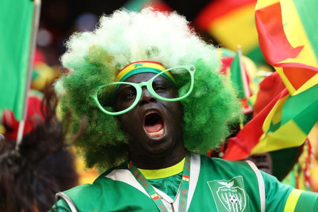 A Senegal fan cheers before the start of the Africa Cup of Nations (CAN) final football match between Senegal and Morocco at the Prince Moulay Abdellah Stadium in Rabat on January 18, 2026. (Photo by FRANCK FIFE / AFP)