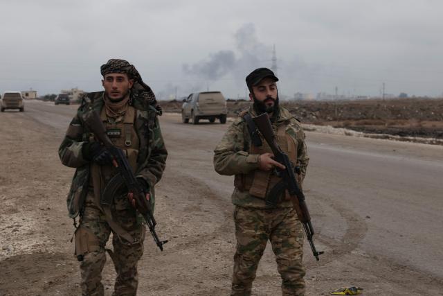 Syrian Ministry of Defense forces enter the northern city of Raqa, on the north bank of the Euphrates River on January 18, 2026. The Syrian President on January 18, announced an agreement with the chief of the Kurdish-led Syrian Democratic Forces that includes a ceasefire after government forces advanced in Kurdish-held areas of the north and east. The presidency published the text of the signed, 14-point deal, which includes integrating the SDF and Kurdish security forces into the defence and interior ministries, the immediate handover of Kurdish-run Deir Ezzor and Raqa provinces to the government, and for Damascus to take responsibility for Islamic State group prisoners and their families held in Kurdish-run jails and camps. (Photo by Bakr ALkasem / AFP)