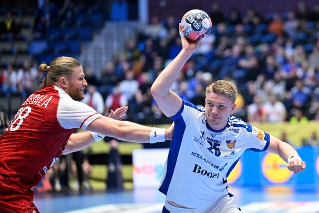 Poland's left back #48 Tomasz Gebala (L) and Iceland's centre back #25 Haukur Thrastarson vie for the ball during the men's EHF Euro 2026 preliminary round group F handball match Poland v Iceland in Kristianstad, Sweden, on January 18, 2026. (Photo by Johan Nilsson/TT / TT NEWS AGENCY / AFP) / Sweden OUT