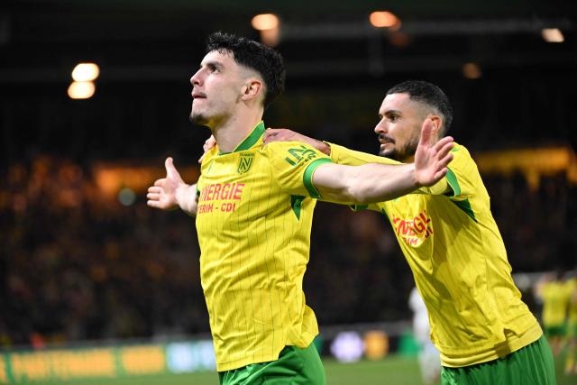 Nantes' French forward #10 Matthis Abline celebrates a  goal with Nantes' French midfielder #20 Remy Cabella during the French L1 football match between FC Nantes and Paris FC at the Stade de la Beaujoire–Louis Fonteneau in Nantes, western France, on January 18, 2026. (Photo by Sebastien Salom-Gomis / AFP)