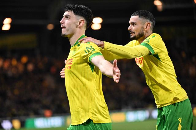 Nantes' French forward #10 Matthis Abline (L) celebrates a  goal with Nantes' French midfielder #20 Remy Cabella during the French L1 football match between FC Nantes and Paris FC at the Stade de la Beaujoire–Louis Fonteneau in Nantes, western France, on January 18, 2026. (Photo by Sebastien Salom-Gomis / AFP)