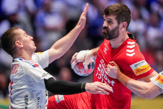 Montenegro's left back #87 Vuko Borozan (R) holds the ball during the men's EHF Euro 2026 preliminary round handball match Montenegro vs Faroe Islands in Oslo, Norway, on January 18, 2026. (Photo by Cornelius Poppe / NTB / AFP) / Norway OUT