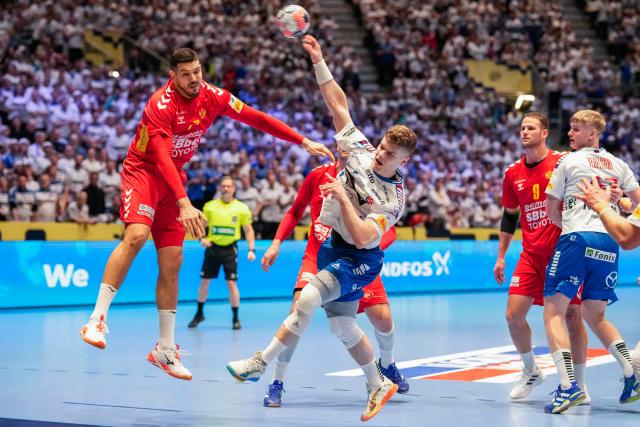 Faroes' left back #78 Oli Mittun (C) throws the ball during the men's EHF Euro 2026 preliminary round handball match Montenegro vs Faroe Islands in Oslo, Norway, on January 18, 2026. (Photo by Cornelius Poppe / NTB / AFP) / Norway OUT