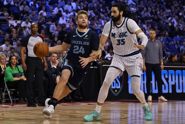 Memphis Grizzlies’ US point guard #24 Cam Spencer (L) dribbles around Orlando Magic’s Georgian center #35 Goga Bitadze (R) during the 2025/2026 NBA season basketball match between the Memphis Grizzlies and Orlando Magic at the O2 Arena in London on January 18, 2026. (Photo by Glyn KIRK / AFP)