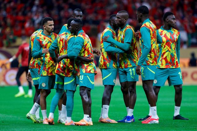 Senegal's players arrive on the field to warm up before the start of the Africa Cup of Nations (CAN) final football match between Senegal and Morocco at the Prince Moulay Abdellah Stadium in Rabat on January 18, 2026. (Photo by Abdel Majid BZIOUAT / AFP)