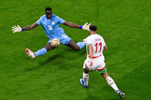 Senegal's goalkeeper #16 Edouard Mendy and Morocco's midfielder #11 Ismael Saibari vie during the Africa Cup of Nations (CAN) final football match between Senegal and Morocco at the Prince Moulay Abdellah Stadium in Rabat on January 18, 2026. (Photo by Paul ELLIS / AFP)