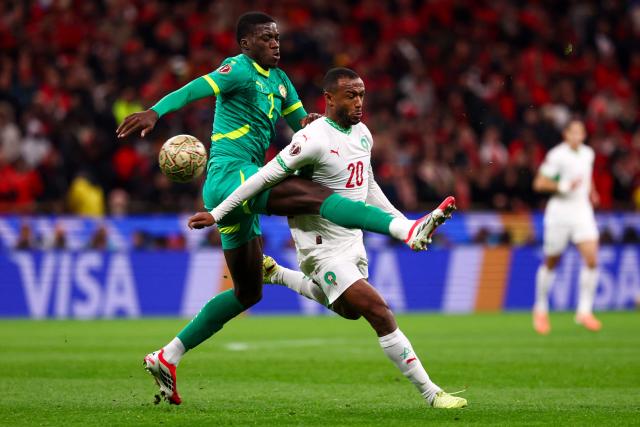 TOPSHOT - Morocco's forward #20 Ayoub El Kaabi fights for the ball with Senegal's defender #02 Mamadou Sarr during the Africa Cup of Nations (CAN) final football match between Senegal and Morocco at the Prince Moulay Abdellah Stadium in Rabat on January 18, 2026. (Photo by FRANCK FIFE / AFP)