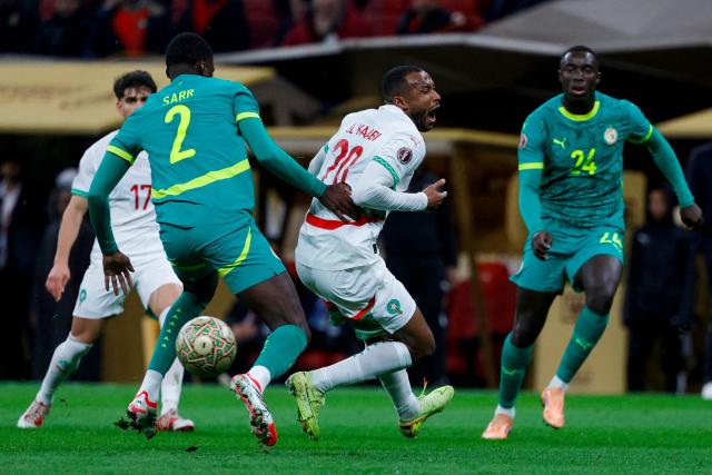 Morocco's forward #20 Ayoub El Kaabi fights for the ball with Senegal's defender #02 Mamadou Sarr during the Africa Cup of Nations (CAN) final football match between Senegal and Morocco at the Prince Moulay Abdellah Stadium in Rabat on January 18, 2026. (Photo by Abdel Majid BZIOUAT / AFP)