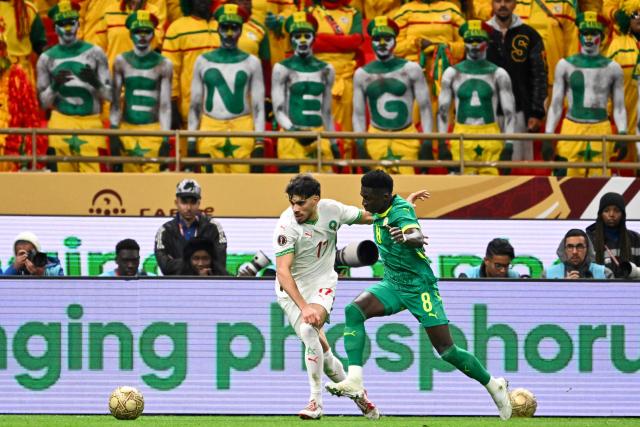 Morocco's midfielder #17 Abde Ezzalzouli and Senegal's midfielder #08 Lamine Camara vie during the Africa Cup of Nations (CAN) final football match between Senegal and Morocco at the Prince Moulay Abdellah Stadium in Rabat on January 18, 2026. (Photo by SEBASTIEN BOZON / AFP)