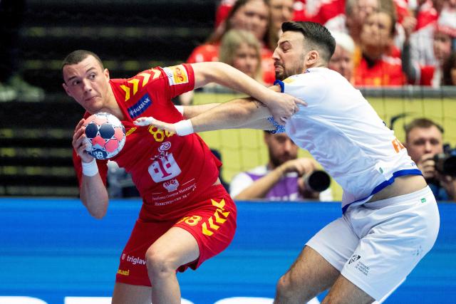 North Macedonia's centre back #88 Pavle Atanasijevikj (L) and Portugal's left back #20 Miguel Neves vie for the ball during the men's EHF Euro 2026 preliminary round group B handball match North Macedonia vs Portugal in Herning, Denmark, on January 18, 2026. (Photo by Bo Amstrup / Ritzau Scanpix / AFP) / Denmark OUT