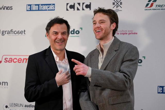 French director Francois Ozon (L) and Frecnh actor Benjamin Voisin pose during the photocall of the 29th 'Ceremonie des Lumieres' cinema awards ceremony at the Institut du Monde Arabe (IMA) in Paris on January 18, 2026. (Photo by Martin LELIEVRE / AFP)