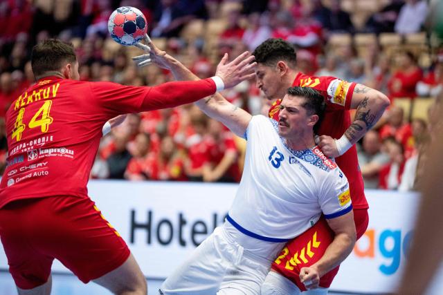 Portugal's left back #13 Salvador Salvador (C), North Macedonia's pivot #44 Mihail Alarov (L) and North Macedonia's pivot #42 Marko Stojkovikj (R) vie for the ball during the men's EHF Euro 2026 preliminary round group B handball match North Macedonia vs Portugal in Herning, Denmark, on January 18, 2026. (Photo by Bo Amstrup / Ritzau Scanpix / AFP) / Denmark OUT